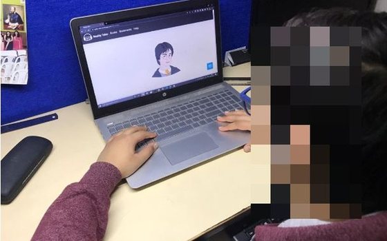 A participant talking to a story character in Reality Tales on a laptop